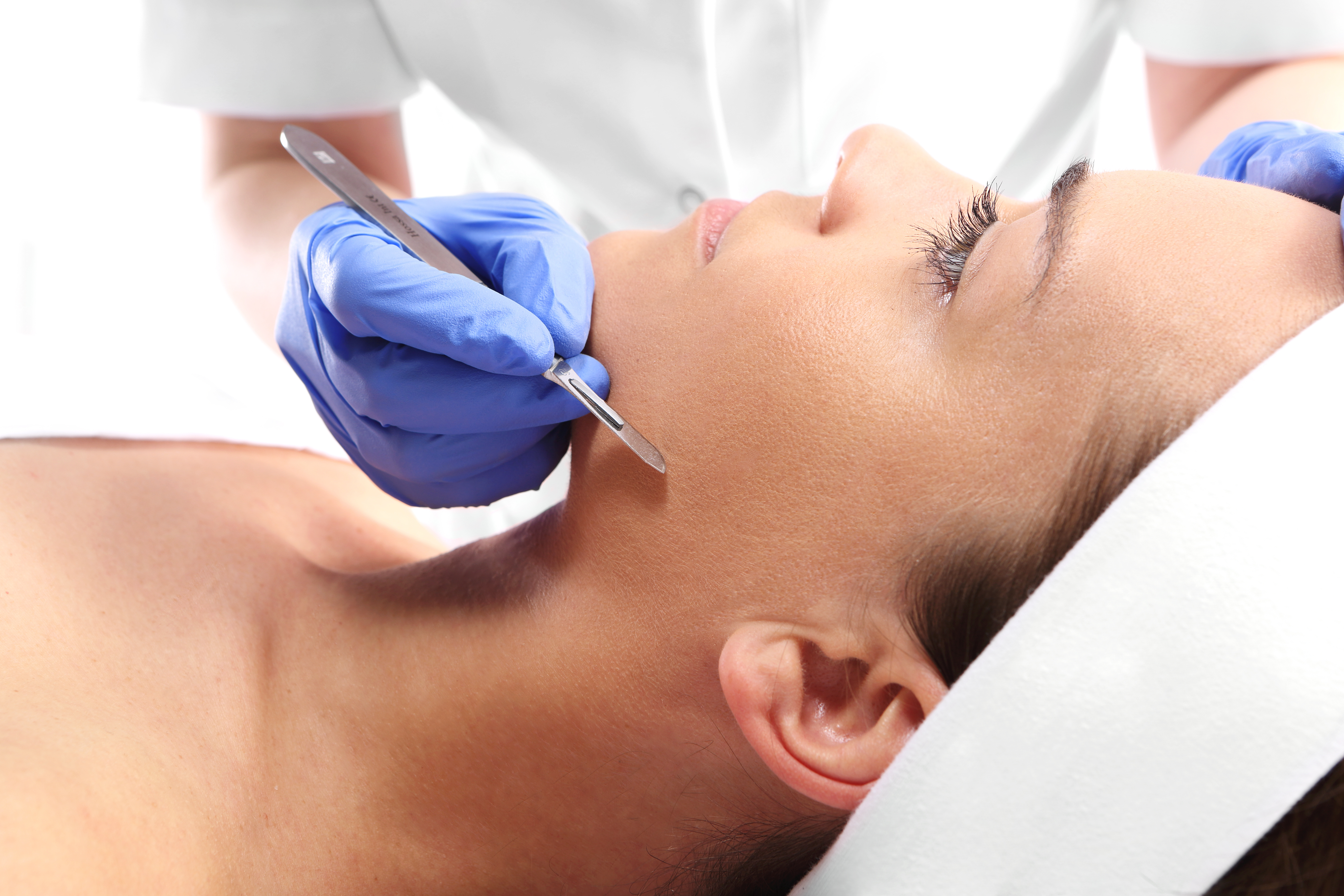 Aesthetician performing a Dermaplaning exfoliation treatment at Desert Med Rejuvenation.