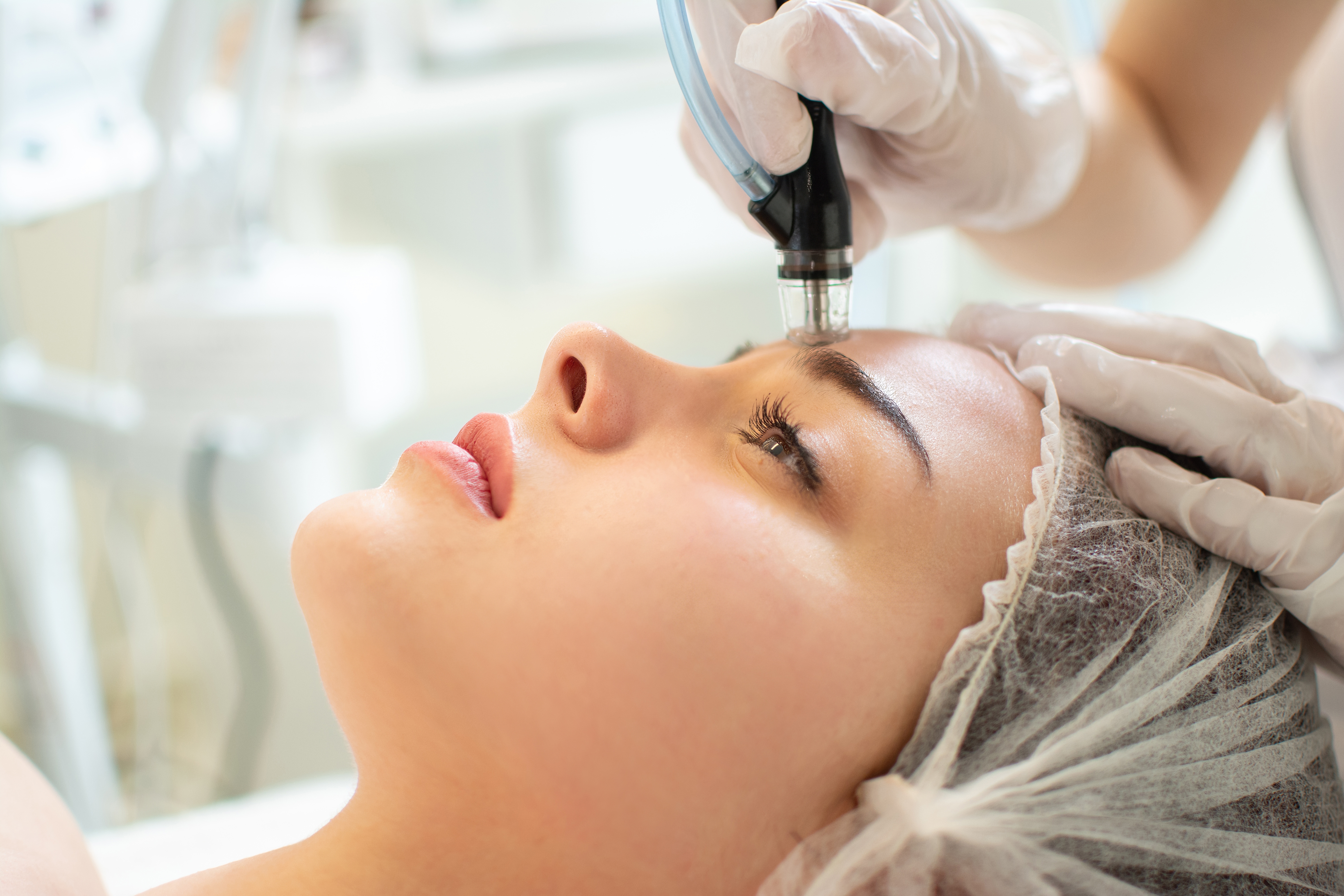 Close-up of a HydraFacial device gliding over a patient’s skin at Desert Med Rejuvenation.